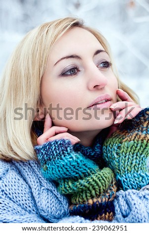 Excellent winter beauty portrait of blonde girl. Winter frozen make up. Blue clothes, winter concept. Fashion girl.