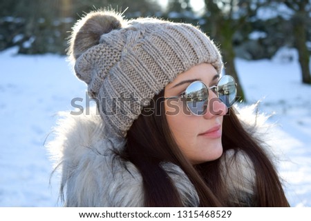 Portrait Of A Girl In A Hat With A Pompon Against The Background Of A Winter Portrait Of A Girl In A Hat With A Pompon Against The Background Of A Winter