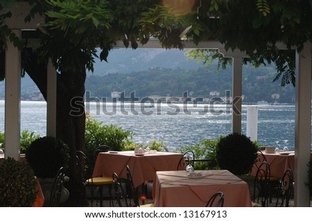 cafe tables on the edge of lake como, italy