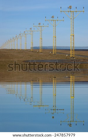 Runway lights with water reflections