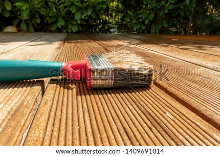 Similar – Image, Stock Photo Glaze. Woodwork, painting wood. Hand of the craftsman painting a wooden door. Concept of renovation work, carpentry and woodwork. painter, painting wooden surface, wood preservation