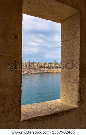 View to Valletta Waterfront from the window of The Gardjola in Senglea, Malta. The Gardjola is a stone vedette at Senglea Bastion point. It was used to serve as a lookout post to guard the harbour. Stock fotó © 