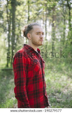 long haired hipster man in the forest portrait