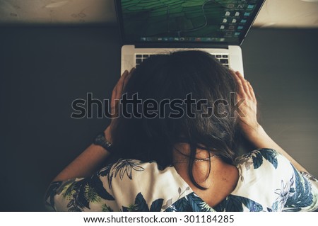 Tired office worker woman sleeping right on her laptop's keyboard