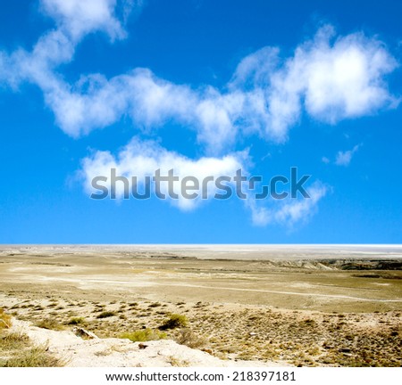 desert  against a blue sky with clouds