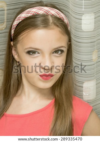 little girl with makeup portrait, smiling at the camera