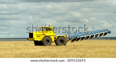 District Bulaevo SKO, Kazakhstan - August 24, 2015: Yellow K-701 heavy duty tractor ready for plowing, autumn landscape