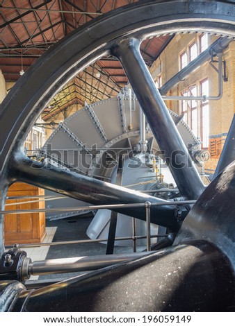 LEMMER, NETHERLANDS - 2 MARCH 2014: Flywheel inside the machine room of the historic Wouda steam pumping station from 1920, the largest of its kind ever built still in operation