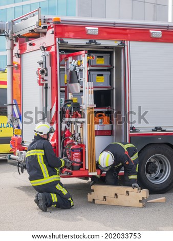 ALMERE, NETHERLANDS - 12 APRIL 2014: Firefighters at work in an enacted emergency scene during the first National Security Day held in the city of Almere