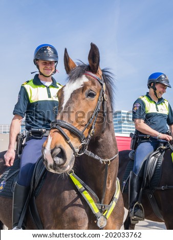 ALMERE, NETHERLANDS - 12 APRIL 2014: Dutch mounted police showing their skills at the first National Security Day held in the city of Almere