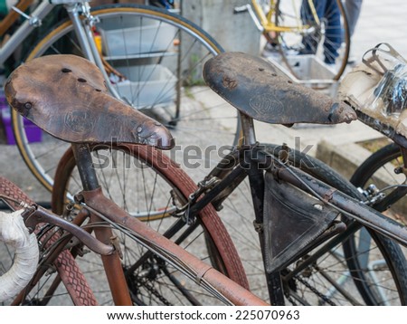 GAIOLE IN CHIANTI, ITALY - 4 OCT. 2014: Leather saddles of vintage bicycles on display at L\'Eroica, a cycling event for owners of vintage bicycles who ride through Tuscany on white gravel roads.