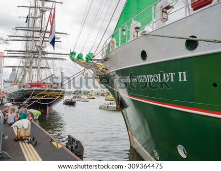 AMSTERDAM - 21 AUGUST 2015: Tall ship von Humboldt II and clipper Amsterdam moored in the port of Amsterdam for Sail 2015. Sail is held every five years and is the world\'s biggest nautical event