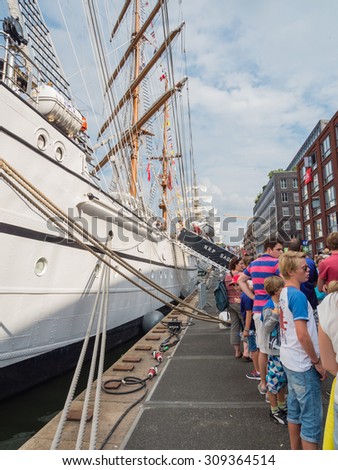 AMSTERDAM - 21 AUGUST 2015: People waiting in line to visit Portuguese tall ship Sagres in Amsterdam harbor at nautical event Sail 2015. Sail is held every five years and attracts two million visitors