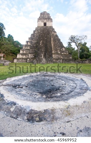 View of altar with the ancient Mayan pyramid \'Temple of the Great Jaguar or Temple 1\' in background in Tikal, Guatemala, Central America.