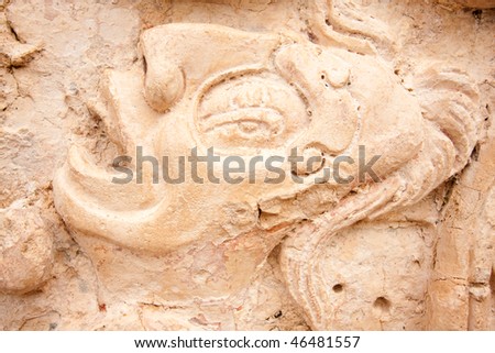 Close up of carving of face on bottom of column in \'The Palace\' at the ancient Mayan city of Palenque. Chiapas, Mexico.