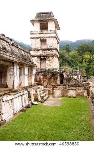 View of tower from inside \'The Palace\' with steamy jungle in background at the ancient Mayan city of Palenque. Chiapas, Mexico.