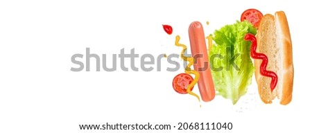 Flying ingredients for a delicious hot dog on a white background. Levitating sausage, tomatoes and lettuce. Banner format. Stock fotó © 