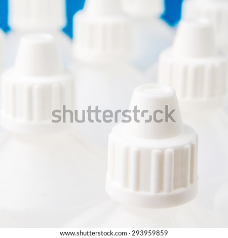 white translucent bottles used in homeopathy with one focused top of a bottle