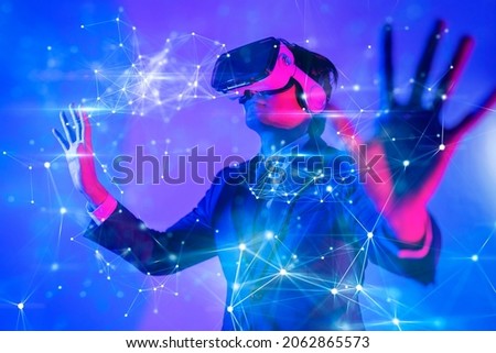 Metaverse digital cyber world technology, man with virtual reality VR goggle playing AR augmented reality game and entertainment, NFT game futuristic lifestyle Photo stock © 
