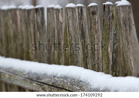 Old wood fence covered with snow