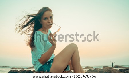 Similar – Image, Stock Photo Charming woman on stony coast