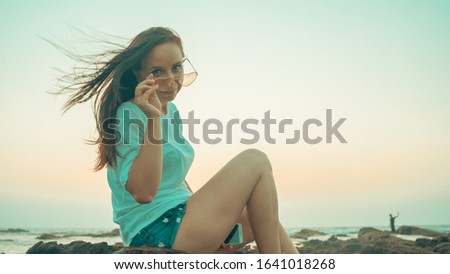 Similar – Image, Stock Photo Charming woman on stony coast