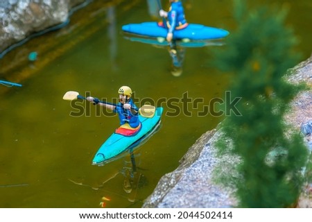 Closeup of tiny model people kyaking on a river Stok fotoğraf © 