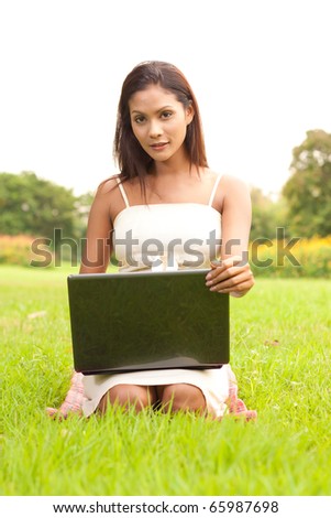 Outdoor portrait of young lady with laptop