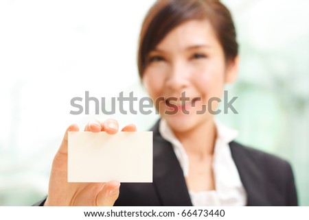 Cheerful woman showing business card