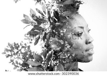 Double exposure portrait of attractive african american woman combined with photograph of leaves