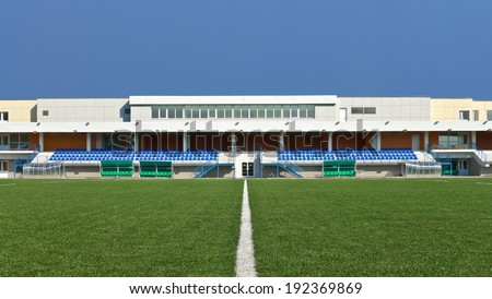 Empty sports field with the white line markings and grandstand stadium