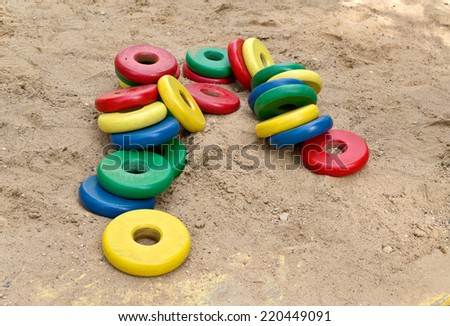Toys to play with sand-pile of wooden colorful discs.Small depth of field.