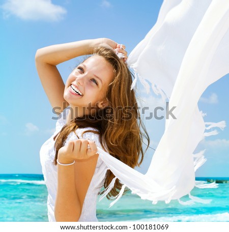 Beautiful Girl With White Scarf on The Beach. Travel and Vacation. Freedom Concept