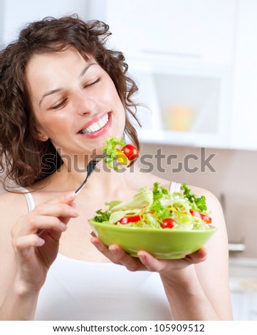 Diet. Beautiful Young Woman Eating Vegetable Salad. Dieting concept.Healthy Food