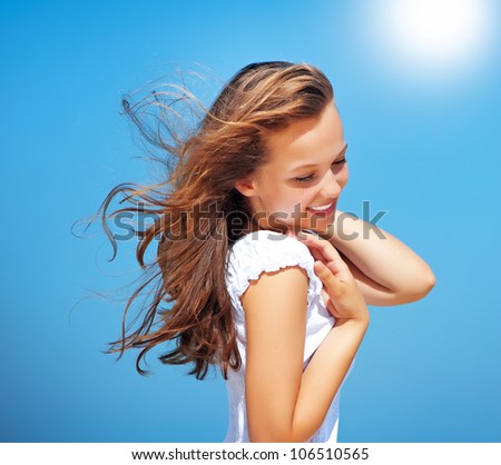 Beautiful Girl  over Blue Sky. Healthy Fluttering Hair