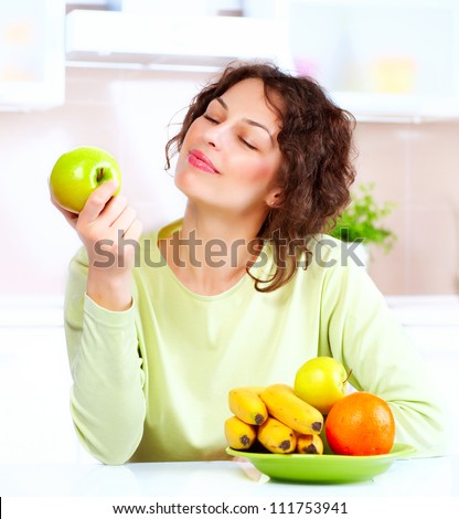 Happy Young Woman Eating Apple.Diet.Dieting concept.Healthy Food. Vegetarian