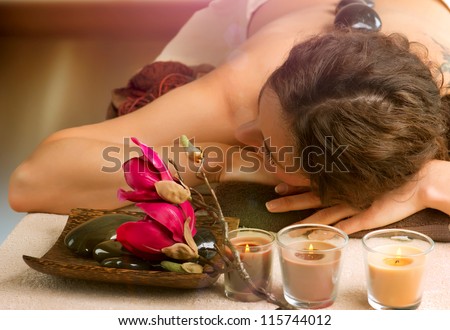 Beautiful Woman in Spa Salon. Spa Stone Massage. Day-Spa Treatment.