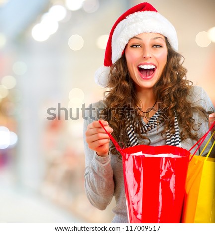 Christmas Shopping. Happy Woman with Shopping Bags in Shopping Mall.Sales. Christmas Gifts.Shopping Mall