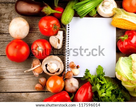 Fresh Organic Vegetables and Spices on a Wooden Background and Paper for Notes.Open Notebook. Diet. Dieting Concept