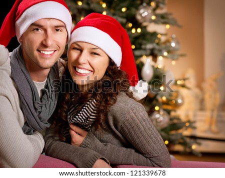 Christmas Couple.Happy Smiling Family at home celebrating.New Year People