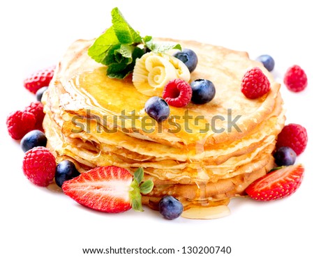 Pancake. Crepes With Berries. Pancakes stack with Strawberry, Raspberry, Blueberry and Syrup isolated on a White Background