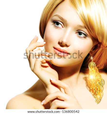 Beauty Blonde Fashion Model Girl With Golden Earrings. Beautiful Hair and Nails. Manicure and Skincare concept