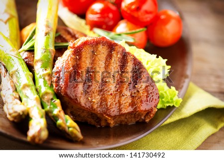 Steak. BBQ Grill Beef Steak Dinner over Wooden Background