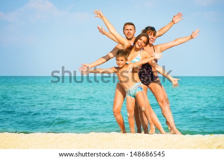 Happy Family  Having Fun at the Beach. Joyful Family. Vacation and Travel concept. Summer Holidays