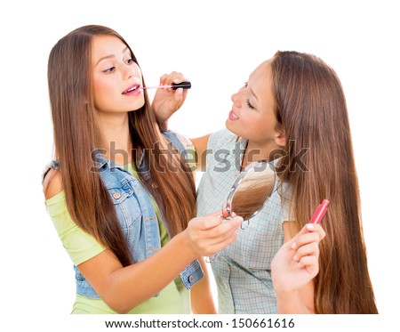 Teenage Girls Applying Make Up And Looking In The Mirror. Pretty Teens ...