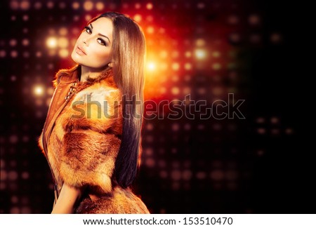 Beauty Fashion Model Girl in Fox Fur Coat. Beautiful Woman in Luxury Red Fur Jacket