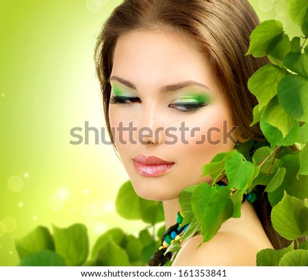 Beautiful Girl with Green Leaves. Fresh Skin. Skincare concept. Nature. Spring Beauty Woman outdoors. Perfect Face skin. Organic cosmetics