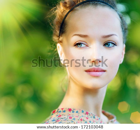 Beauty Teenage Model Spring Girl over Nature Green Background. Beauty Girl outdoors. Clean skin. Blue eyes. Beautiful face