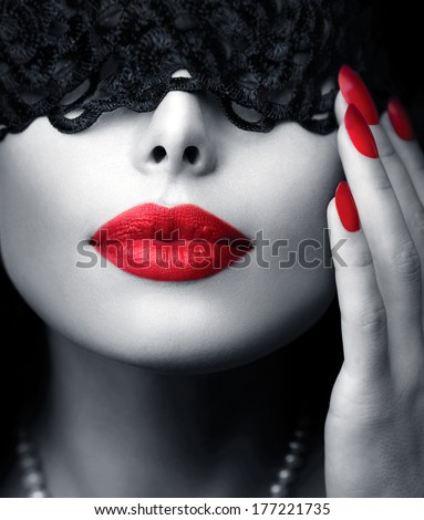 Beautiful Woman with Black Lace mask over her Eyes. Red Sexy Lips and Nails closeup. Sensual Mouth. Manicure and Makeup. Make up concept. Passion. Black and white portrait