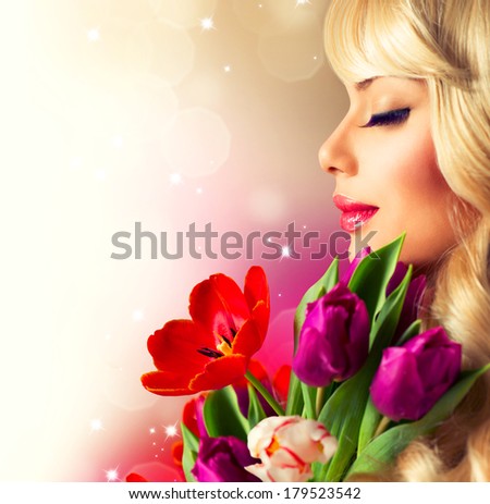 Beauty Woman with Spring Flower bouquet. Cheerful girl with a Bouquet of Tulip flowers. Isolated on a white background. Happy surprised model woman smelling flowers. Mothers Day